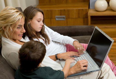 A mother shops with her children online.