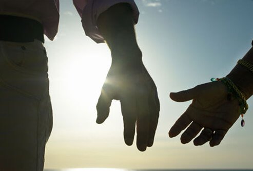 Photo of a couple holding hands.