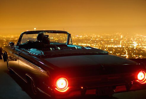 Photo of couple in a convertible.