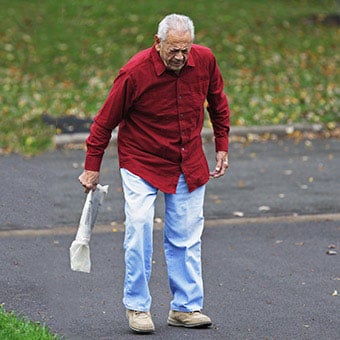 A man with rheumatoid arthritis (RA) limps after retrieving his newspaper.