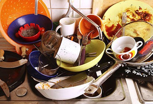 Photo of dirty dishes piling up at the sink.