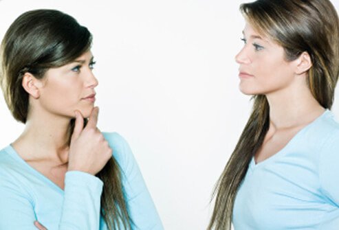 Twin sisters look at each other.