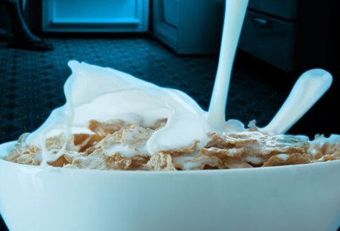 A bowl of milk and cereal, helpful foods for sleeping well.