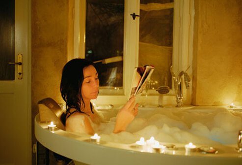 Woman relaxing in the bath, a good way to sleep better.