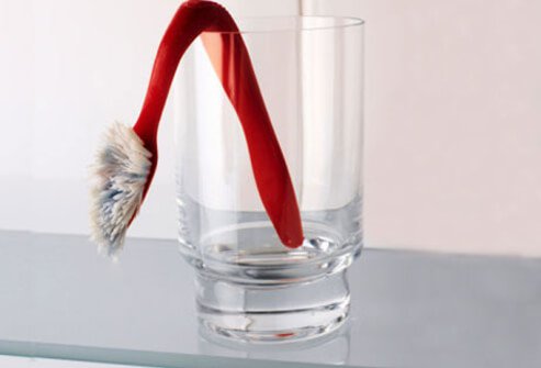 A sagging toothbrush in a glass.