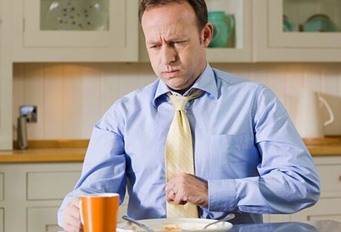 A man with acid reflux after eating. 