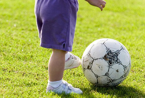 Toddler kicking a soccer ball