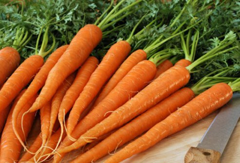 Eat vitamin A-rich carrots in addition to using healthy hair products.