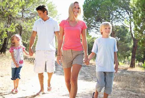 A family goes on a nature walk through the park.