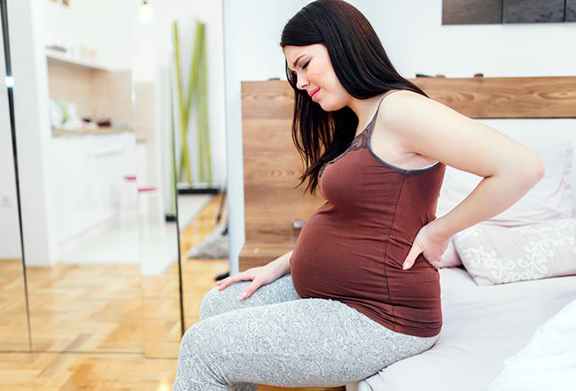 Back pain in pregnancy is usually due to preexisting back pain issues, hormone changes, changes in the abdominal muscles, and posture changes.