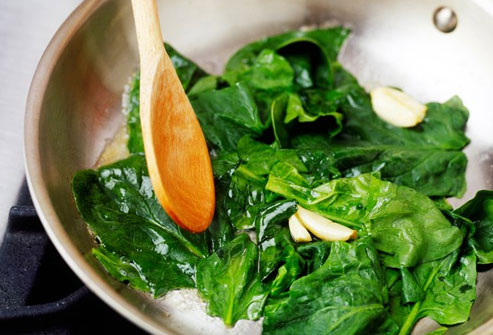 Add raw spinach to salads or cook it as a side dish.