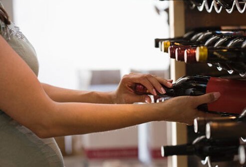 Photo of woman buying wine.