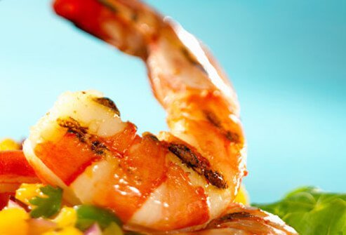 Baking fish -- with herbs, veggies, and lemon juice -- adds very few calories or fat to the dish.