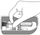 Remove the syringe with attached vial adapter from the tray - Illustration